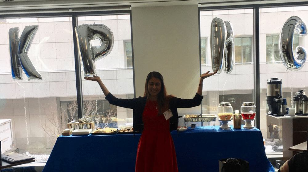 Quinlan Ramble to Boston participant Mashal Hassan posing for a photo in front of KPMG balloons.